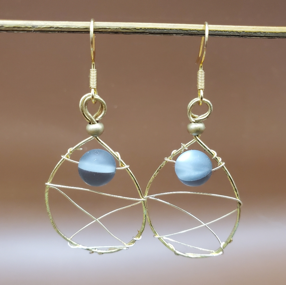 Gold woven wire with a translucent black bead